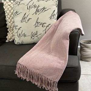 Throw in soft, woven chenille with fringe at short sides.